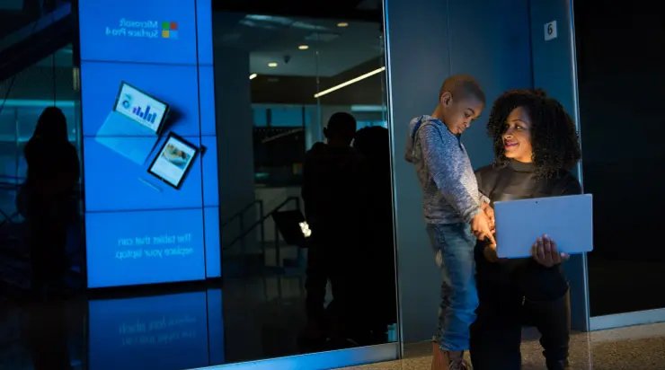A man and woman standing in front of a mirror.