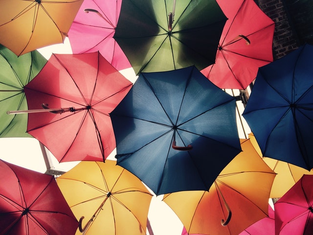 A bunch of umbrellas that are all open up