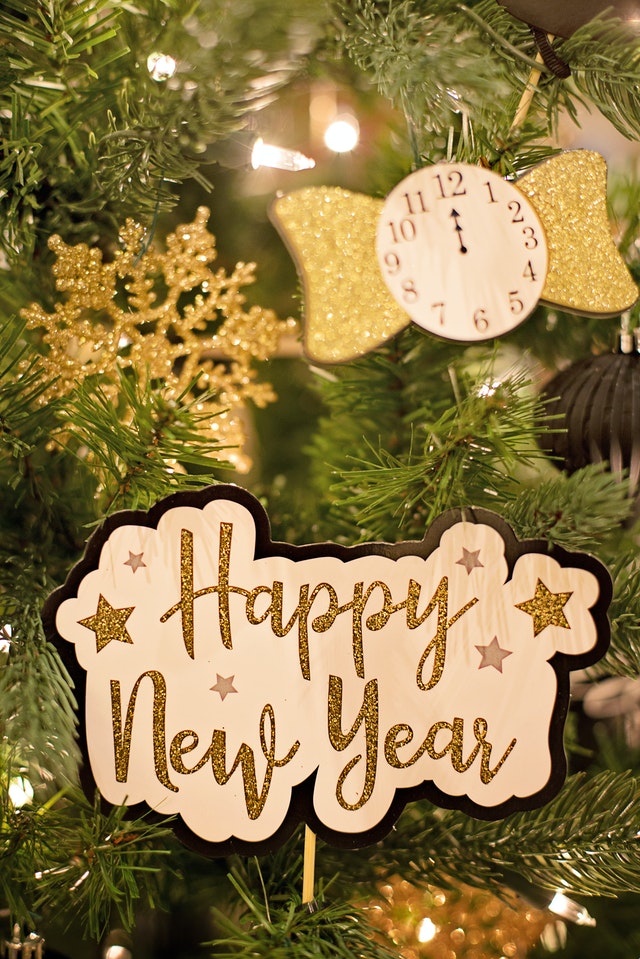 A wooden sign that says happy new year.