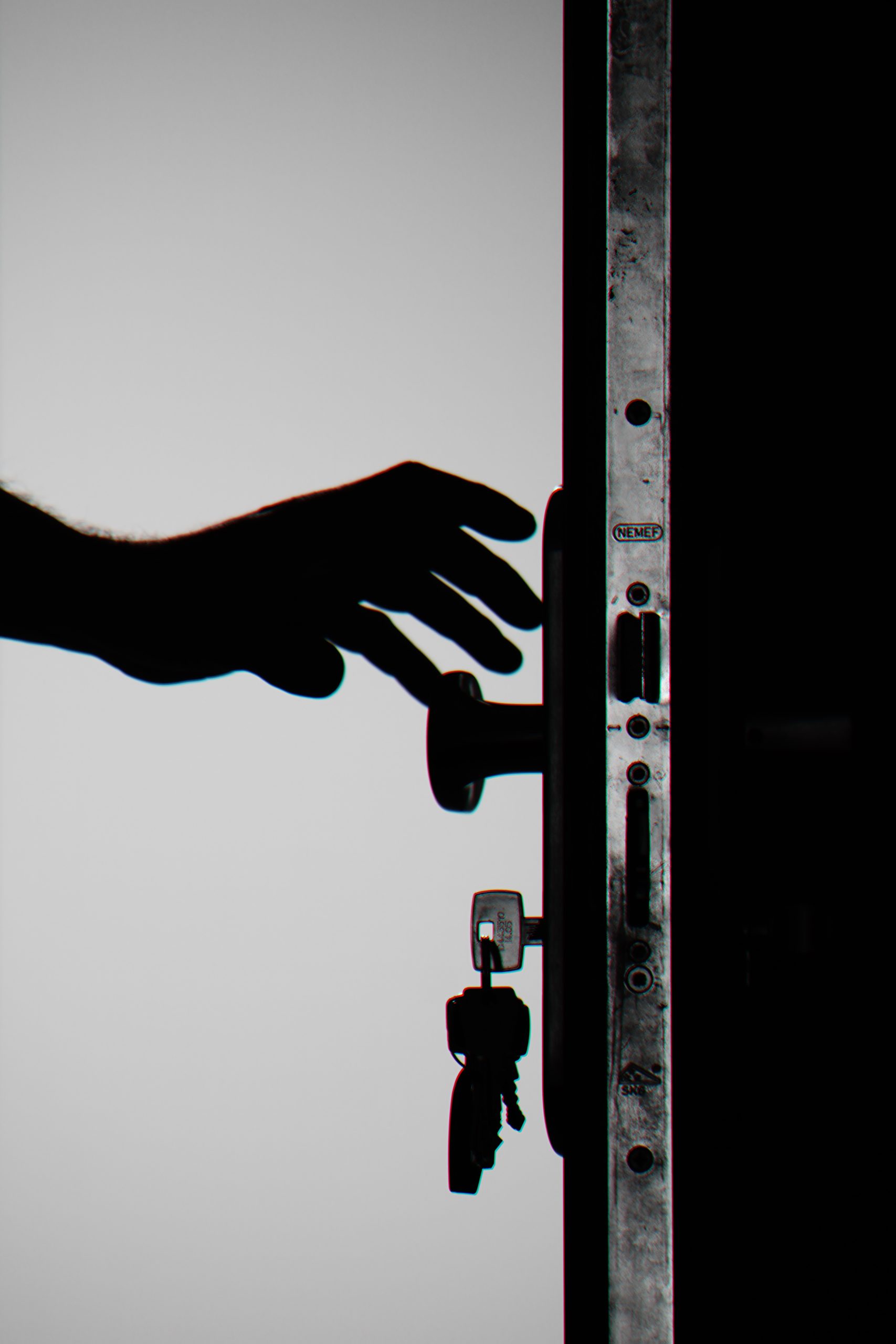 A hand is reaching for the door handle.