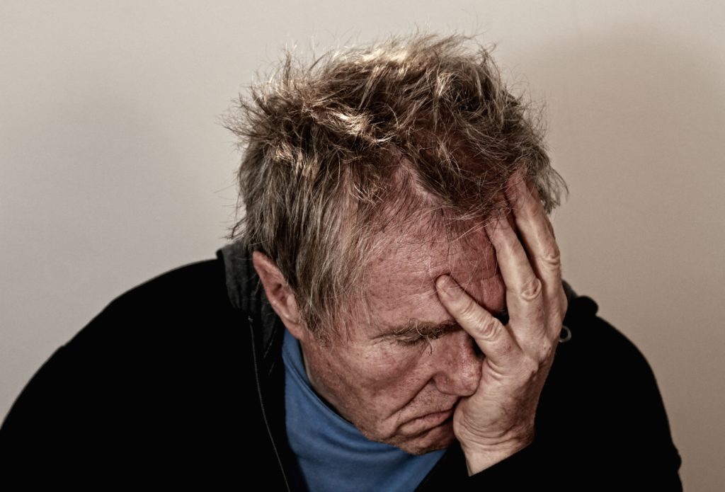 A man with his head in his hands.