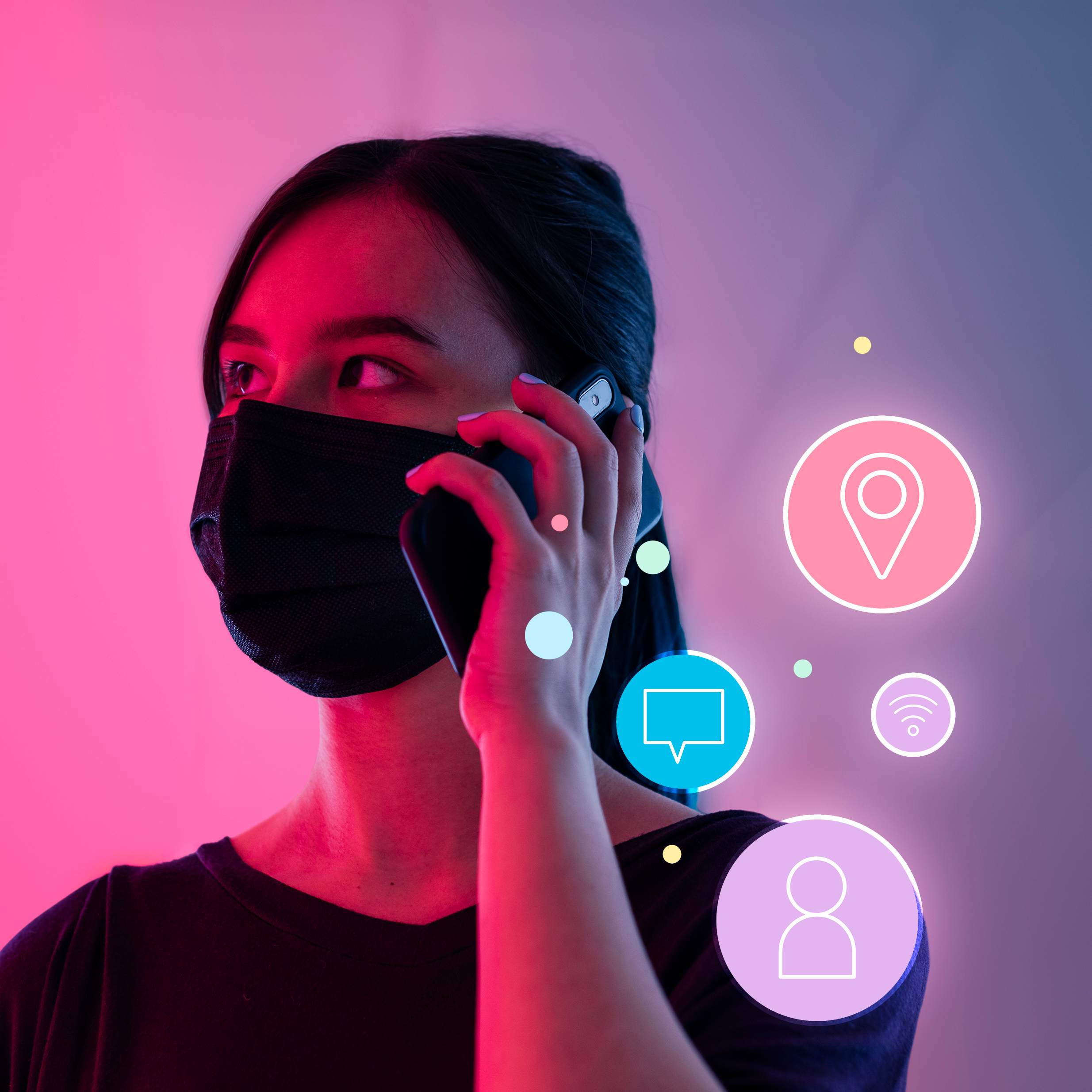 A woman wearing a black mask and holding her phone.