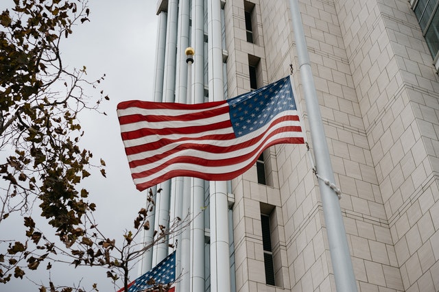 A flag flying in front of a building.